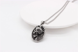 Detailed macro view of a vintage silver skull pendant on a rugged box chain