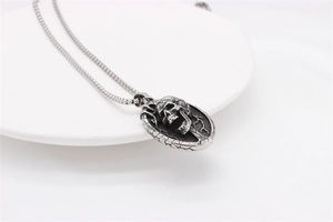 Detailed close-up of retro silver skull pendant with vintage texture and box chain