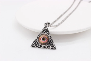 Macro shot of retro steel All-seeing Eye pyramid pendant with vintage silver finish