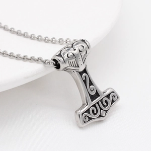 Vintage Thor's Hammer Mjölnir pendant necklace with Viking runes on a white background