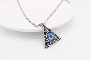 Detail view of gothic pyramid pendant necklace with blue eye of providence on white tray