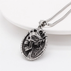 Retro gothic skull relief pendant necklace in vintage silver finish on white display