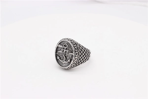 Macro detail of gothic anchor seal ring with vintage oxidized silver relief patterns