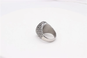 Detailed view of vintage punk signet ring with intricate woven texture on silver band