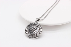 Macro shot of Viking Vegvisir compass pendant with rune engravings and stainless steel chain