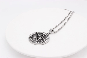 Detailed view of Viking pentagram pendant with Norse runes and vintage box chain necklace