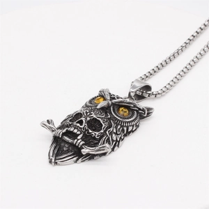 Vintage owl skull pendant necklace in antique silver with yellow gemstone eyes