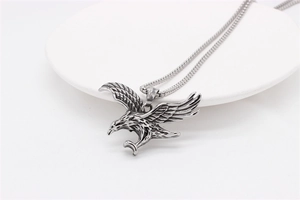 Detailed view of vintage eagle pendant with textured wings and stainless steel box chain