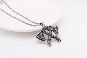 Detail of vintage Nordic Viking double axe pendant with intricate engraved totems