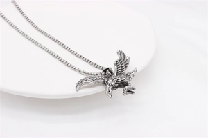 Detailed macro view of retro eagle pendant showing intricate wing feather textures