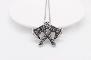 Macro shot of Viking double axe pendant with intricate Nordic engravings and silver finish
