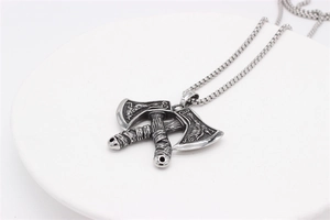 Macro detail of Nordic Viking double axe pendant with intricate dragon totem carvings