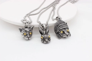 Macro shot of retro rabbit and cat titanium steel pendants with detailed texture