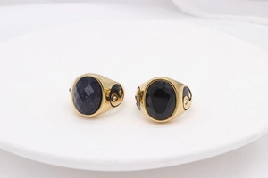 Macro detail of gold-plated signet ring with blue sandstone and black onyx inlay