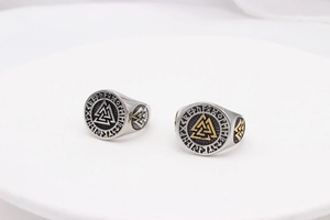 Detail shot of vintage Viking Valknut rings featuring intricate Norse runes and aged steel finish