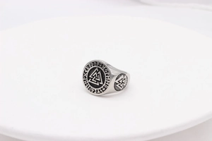 Detail view of a vintage Viking signet ring with Valknut symbol and Norse runes engraving