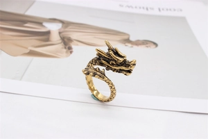 Detail shot of vintage dragon ring in antique gold finish with textured scales detail
