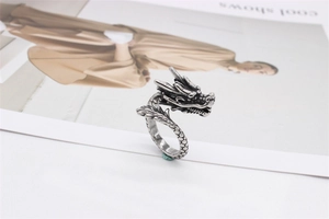 Detailed close-up of retro silver dragon ring with intricate scales and head carvings