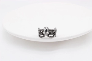 Macro detail of retro octopus tentacle ring with oxidized finish and suction cup textures