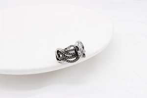Macro detail of retro octopus tentacle ring with realistic silver sucker textures