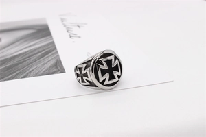 Detailed close-up of retro stainless steel men's ring with iron cross relief pattern