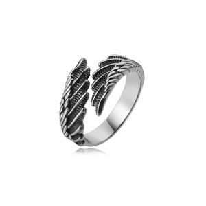 Macro detail of retro stainless steel feather ring featuring an adjustable open band design