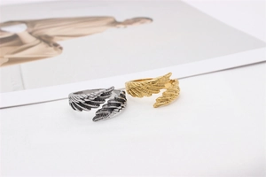 Macro detail of silver and gold vintage feather rings with intricate carved textures