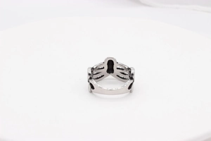 Detailed close-up of retro silver octopus tentacle design on a gothic steel ring
