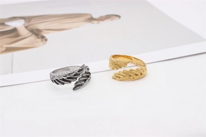 Close-up of retro feather rings in gold and silver finish with adjustable open design