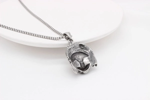 Macro shot of vintage silver Spartan helmet pendant on a box chain for a retro style