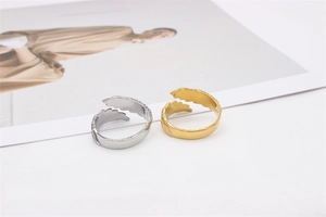 Detailed view of adjustable gold and silver feather wings rings in vintage steel style
