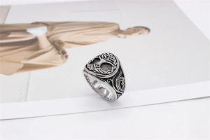 Macro shot of vintage Tree of Life steel ring with oxidized floral relief details