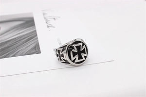 Macro view of vintage silver steel ring featuring black iron cross relief detail