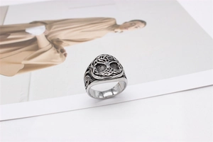 Macro shot of silver Tree of Life signet ring with black oxidized vintage engraving
