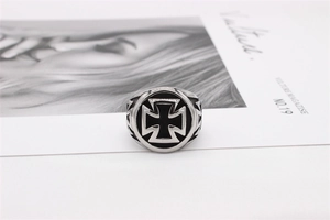 Macro view of vintage silver steel ring featuring black round face and iron cross relief