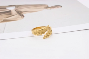 Close-up of golden angel feather ring showing intricate texture and adjustable band