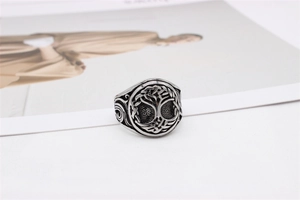 Close-up of vintage stainless steel signet ring featuring an engraved Tree of Life design