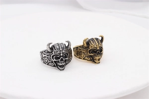 Detailed view of vintage silver and gold skull rings with viking horn engraving details