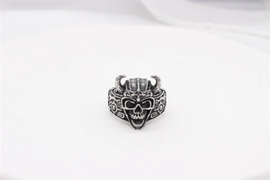 Close-up of vintage viking skull ring with horned helmet and oxidized steel details