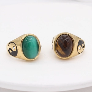 Vintage gold-toned signet rings with green and brown oval stones and Yin Yang motifs