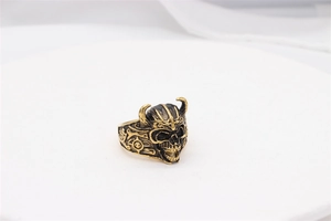 Detailed view of vintage gold viking skull ring with horned helmet and side relief symbols