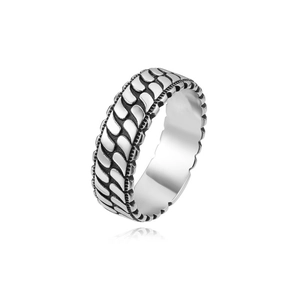 Macro detail of silver vintage ring with textured chain link pattern and polished inner band