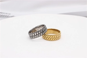 Macro view of vintage-style embossed rings with leaf-like textures in gold and silver