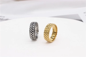 Macro detail of retro striped steel rings in gold and vintage silver on display