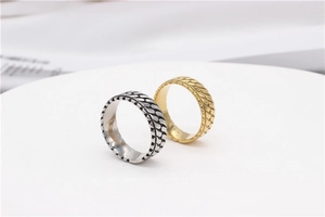 Detail shot of chain-link texture rings in vintage silver and polished gold finish