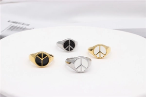 Detailed macro view of vintage peace symbol signet rings in gold and silver finish