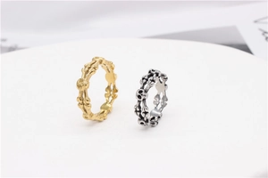 Detail view of retro gothic skull rings in gold and oxidized silver punk style