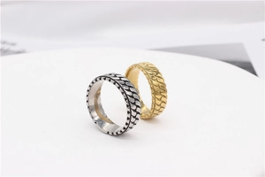 Macro detail of gold and silver vintage rings with textured woven pattern and polished finish