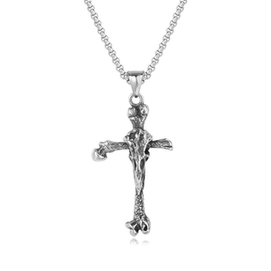 Close-up of vintage silver viking bone cross pendant with skull texture detail