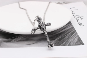 Macro detail of vintage cross pendant with bone textures and antiqued silver finish